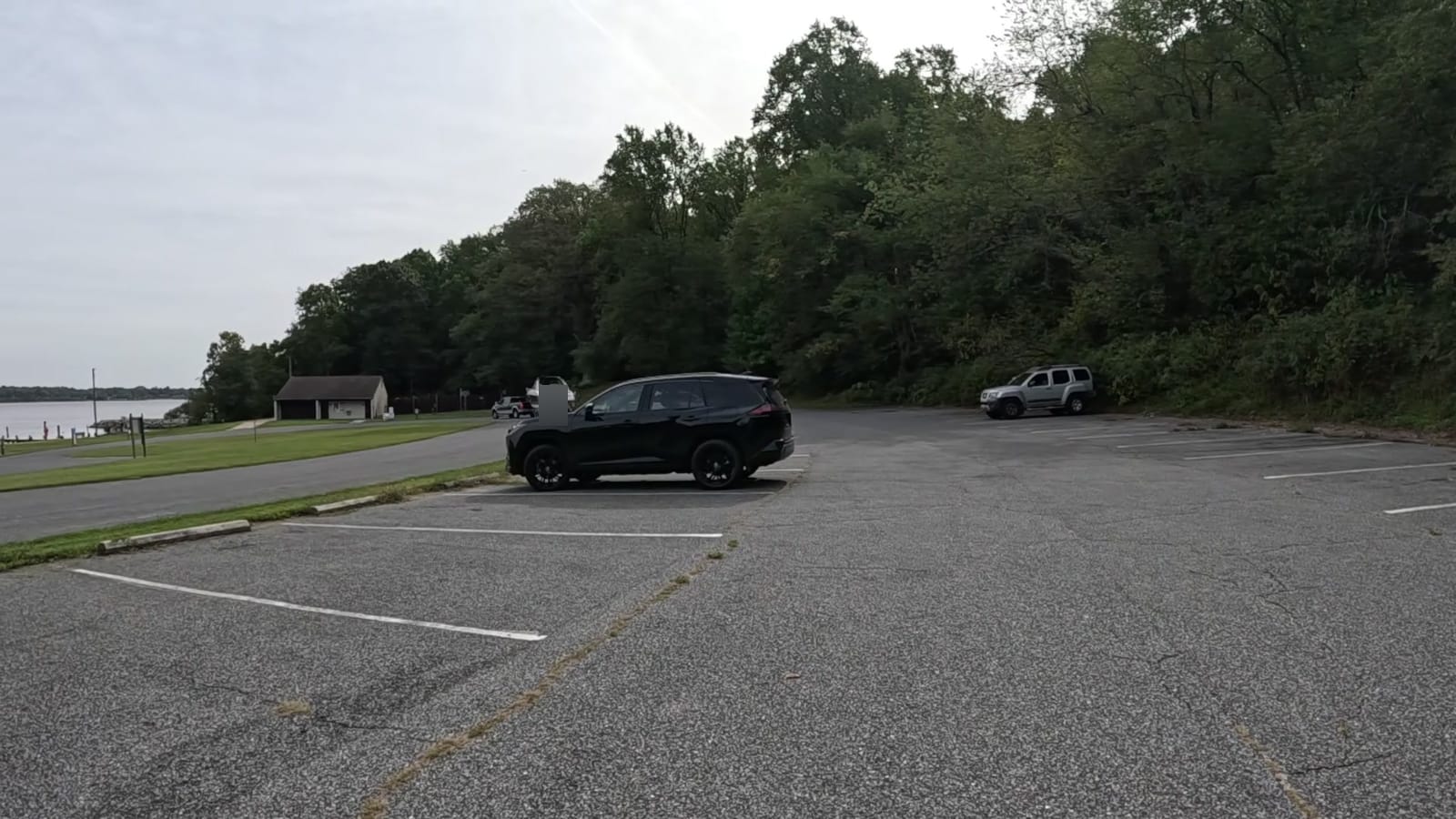 Marked paved parking spaces above the harbor