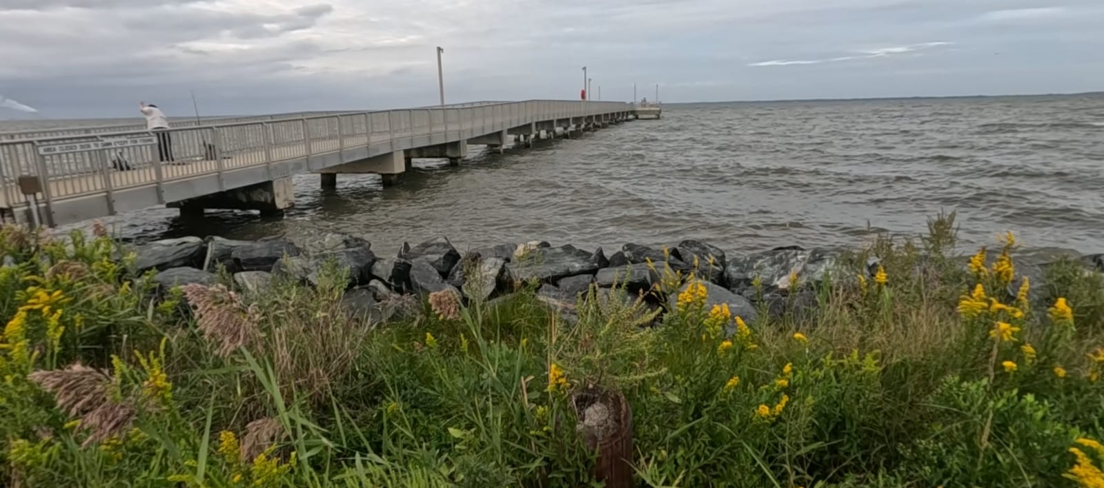 The pier reaches out into Delaware Bay from the rock revetment.